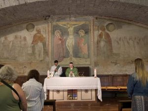 Priest and Deacon celebrating Mass in old church.