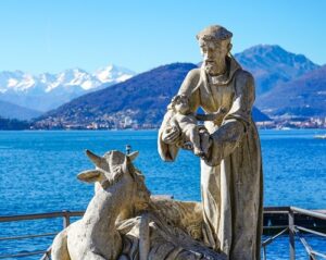 St. Francis and the Christ Child and animals statue near the water.